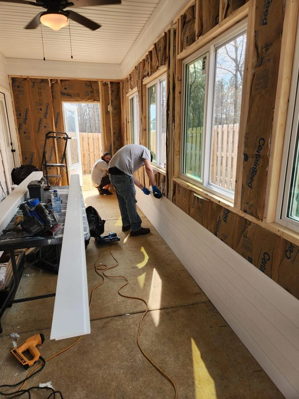 Handyman performing interior maintenance and repair work inside a home